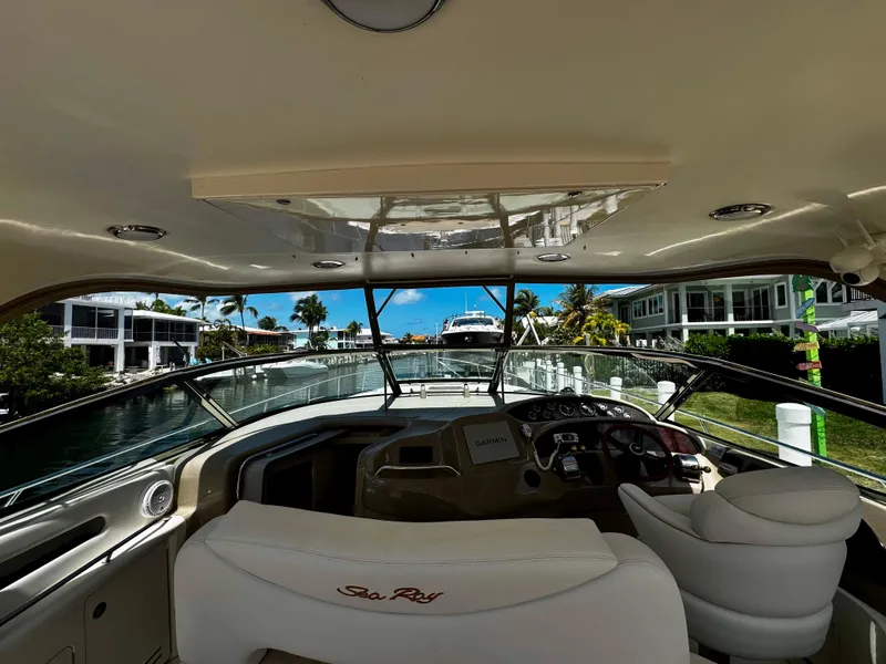 Slide: The Image of Interior view of 2001 Sea Ray 460 Sundancer yacht cockpit with waterfront backdrop. - 8