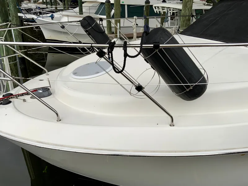 Slide: The Image of 2007 Silverton 33 Convertible boat docked with fenders and railing. - 11