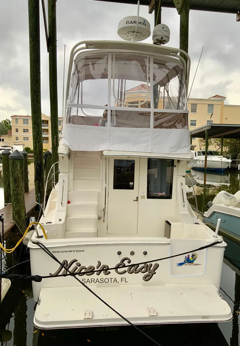 Slide: The Image of 2007 Silverton 33 Convertible boat docked in Sarasota, FL marina. - 13