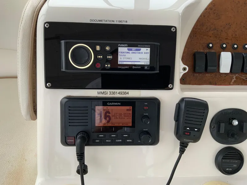 Slide: The Image of Control panel of a 2007 Silverton 33 Convertible boat with Garmin and Fusion systems. - 23