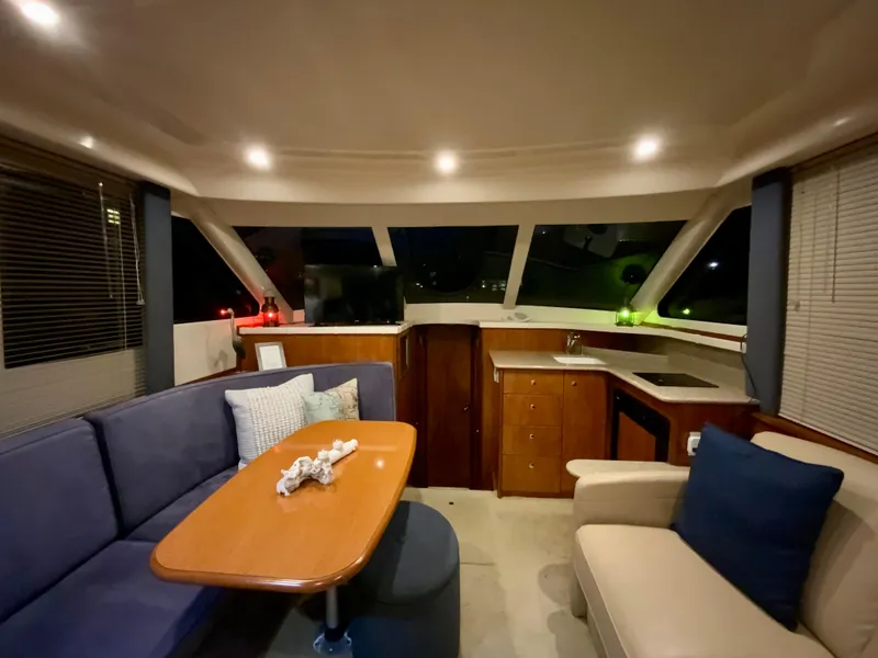 Slide: The Image of Interior of 2007 Silverton 33 Convertible yacht with cozy seating and modern lighting. - 30