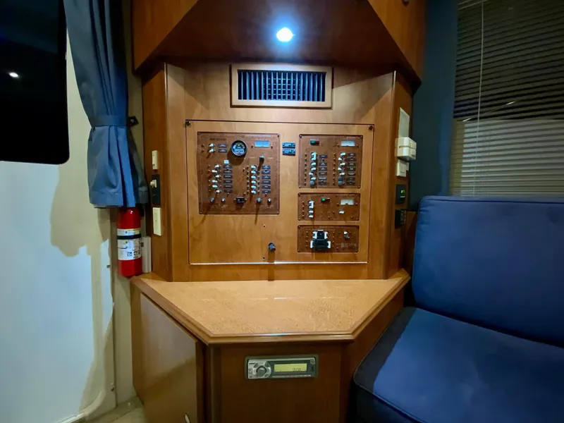 Slide: The Image of Control panel inside 2007 Silverton 33 Convertible yacht, featuring wood finish and seating area. - 37