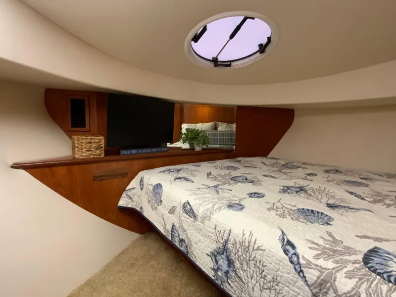 Slide: The Image of Interior of 2007 Silverton 33 Convertible boat with cozy bed and porthole. - 45