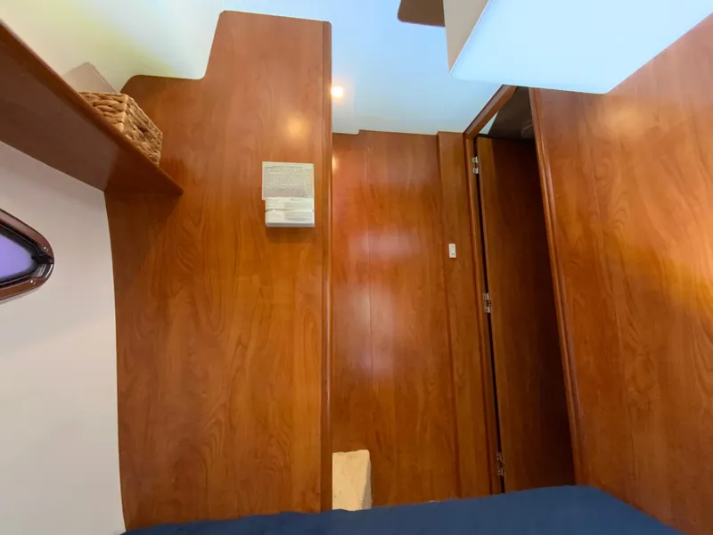 Slide: The Image of Interior of 2007 Silverton 33 Convertible yacht with wooden paneling and cozy cabin space. - 49