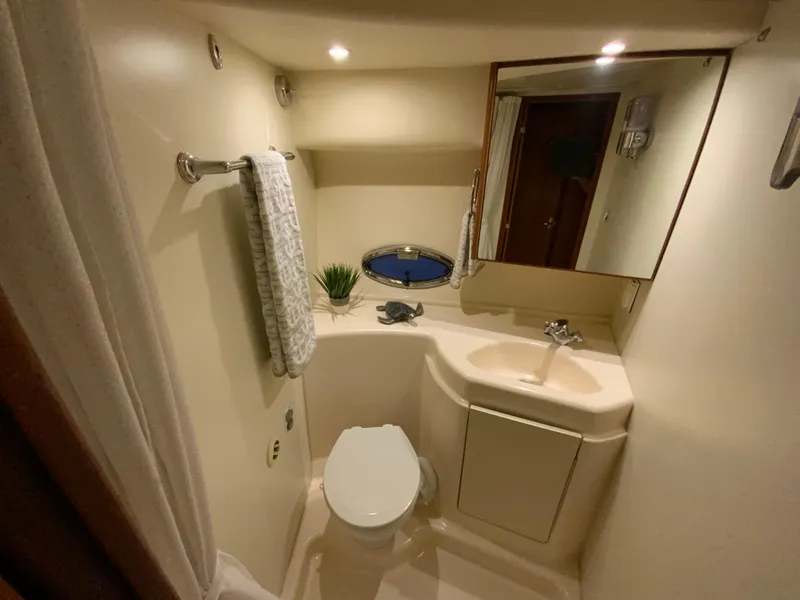 Slide: The Image of 2007 Silverton 33 Convertible bathroom with toilet, sink, mirror, and towel rack. - 50