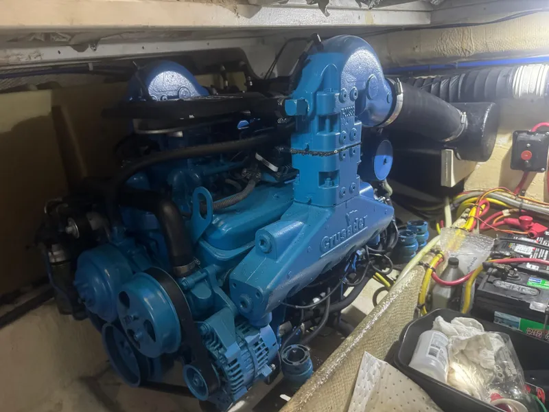 Slide: The Image of Engine room of a 2007 Silverton 33 Convertible boat, featuring a blue marine engine. - 55