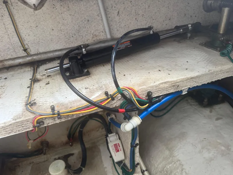 Slide: The Image of Engine compartment of a 2007 Silverton 33 Convertible with hydraulic and electrical components. - 56