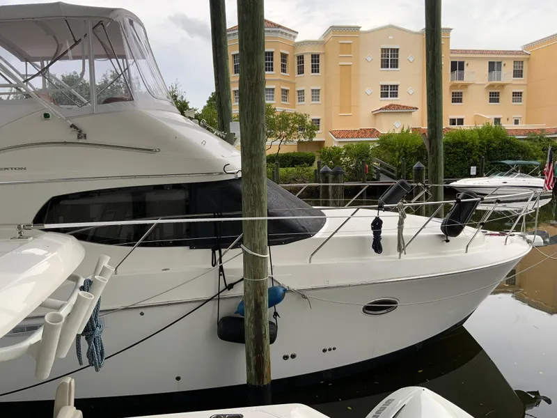 Slide: The Image of 2007 Silverton 33 Convertible yacht docked near waterfront buildings. - 8