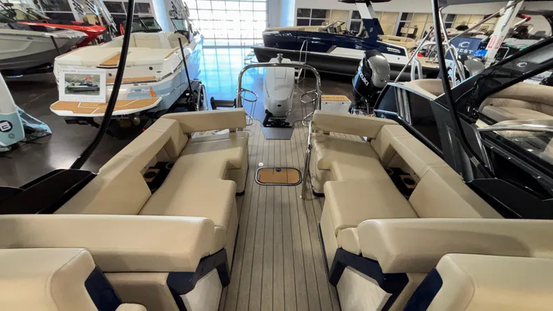 Slide: The Image of 2025 Balise Horizon 26C boat interior with beige seating and sleek design in showroom. - 12
