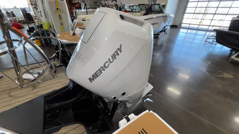 Slide: The Image of Outboard motor on a 2025 Balise Horizon 26C boat in a showroom. - 13