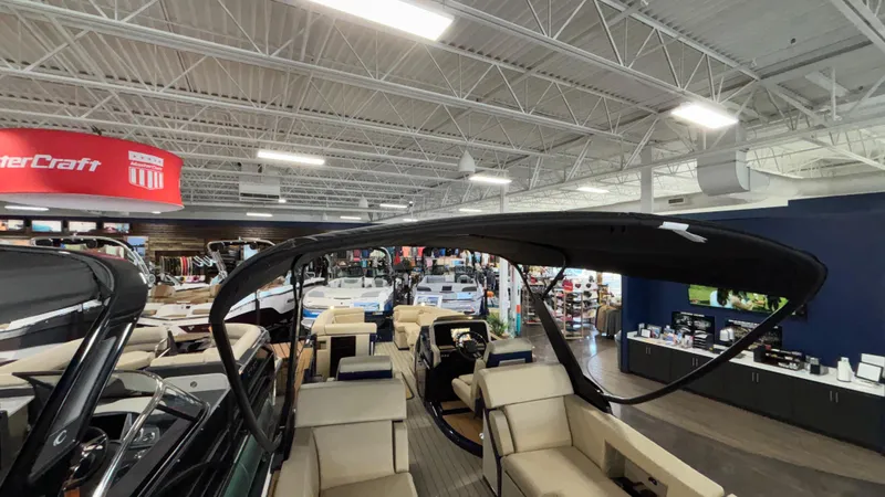 Slide: The Image of Indoor showroom displaying 2025 Balise Horizon 26C boats with modern seating and sleek design. - 14