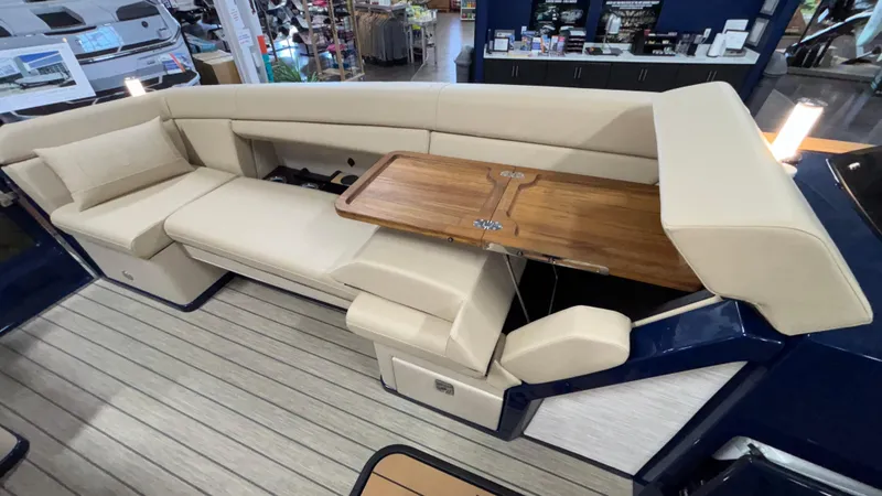 Slide: The Image of Luxurious seating area on 2025 Balise Horizon 26C boat with wooden table and beige upholstery. - 19