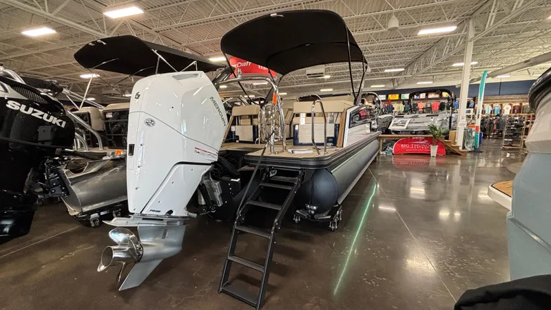 Slide: The Image of 2025 Balise Horizon 26C boat displayed in showroom with modern design and lighting. - 2