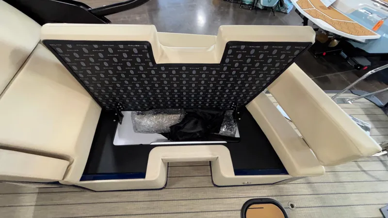 Slide: The Image of Open storage compartment on Balise Horizon 26C boat, 2025 model, with beige seating. - 26