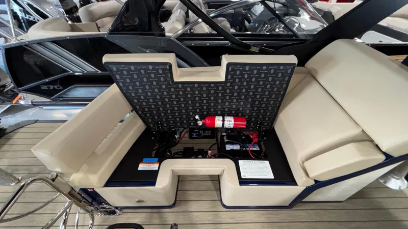 Slide: The Image of Open storage compartment in a 2025 Balise Horizon 26C boat, featuring safety equipment. - 27