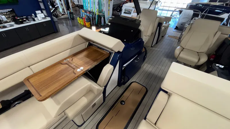 Slide: The Image of 2025 Balise Horizon 26C boat interior with beige seating and wooden table. - 6