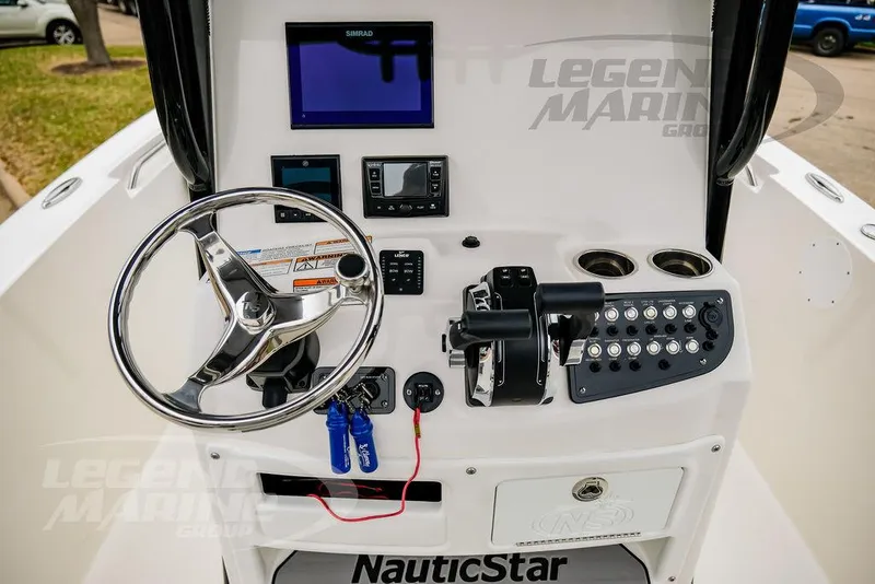 Slide: The Image of 2022 NauticStar 2602 Legacy boat console with steering wheel and control panel. - 10