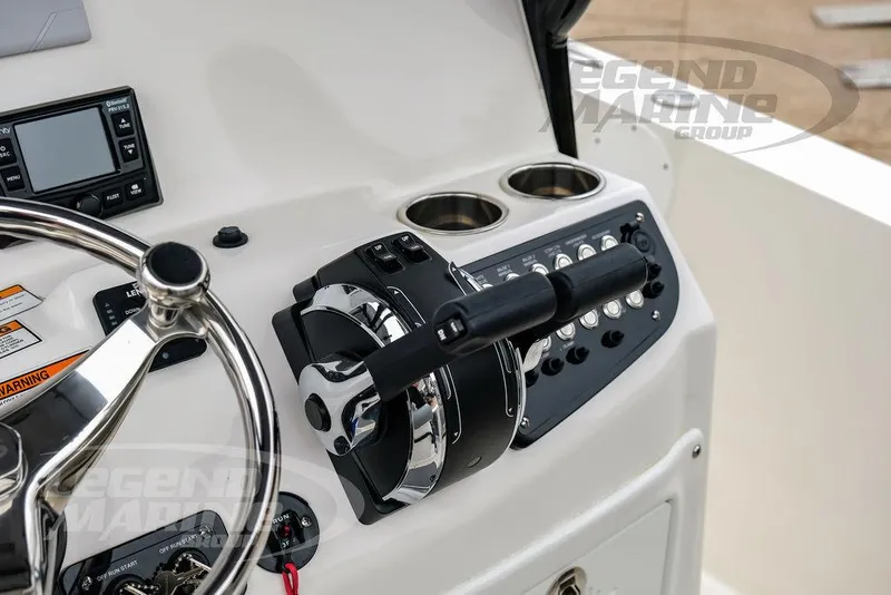 Slide: The Image of 2022 NauticStar 2602 Legacy boat console with steering wheel and controls. - 11