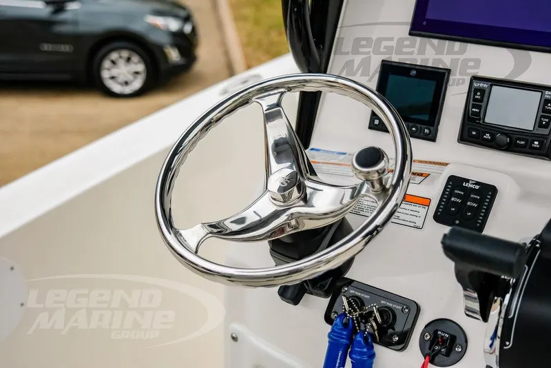 Slide: The Image of 2022 NauticStar 2602 Legacy boat helm with steering wheel and control panel. - 12