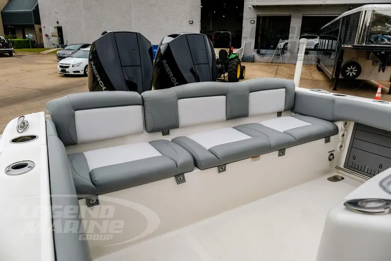 Slide: The Image of 2022 NauticStar 2602 Legacy boat with cushioned seating and dual Mercury engines. - 18