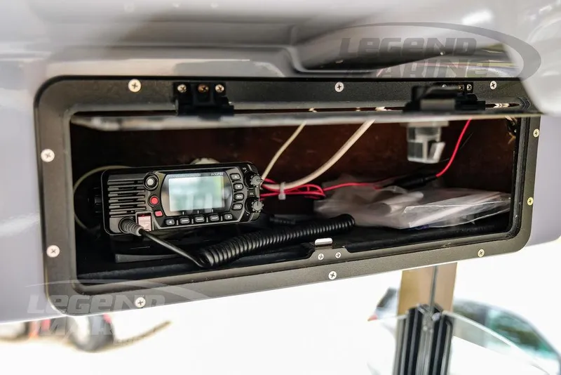 Slide: The Image of 2022 NauticStar 2602 Legacy boat radio compartment with communication equipment. - 20