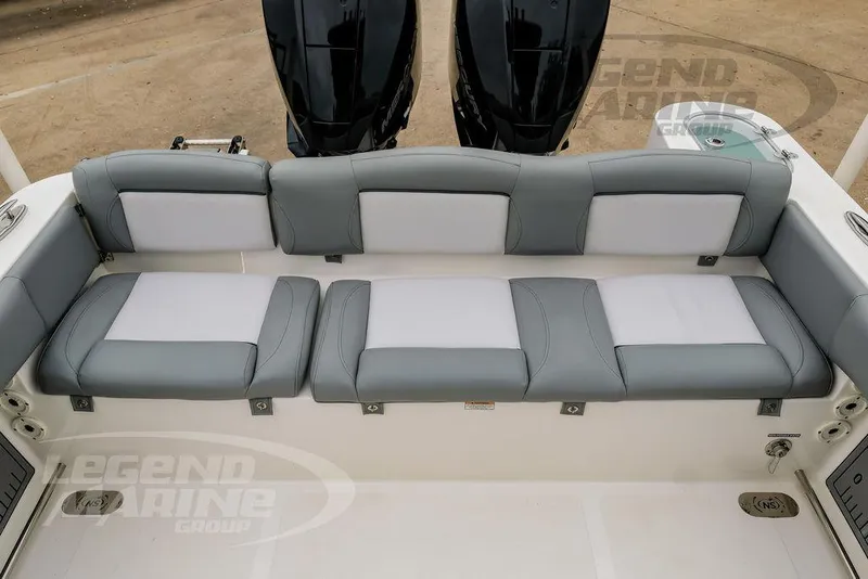 Slide: The Image of 2022 NauticStar 2602 Legacy boat with gray and white cushioned seating. - 22