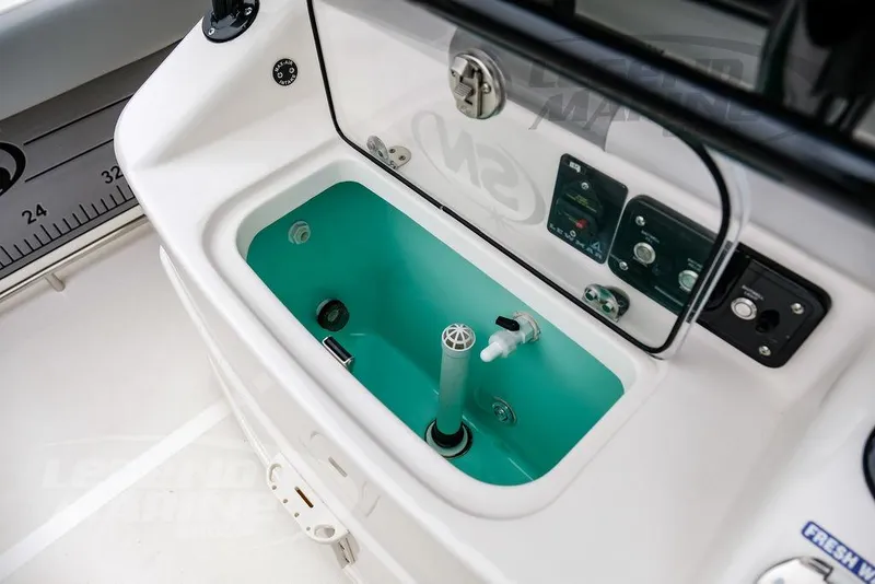 Slide: The Image of 2022 NauticStar 2602 Legacy boat console with livewell and control panel. - 25