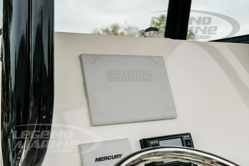 Slide: The Image of 2022 NauticStar 2602 Legacy dashboard featuring Simrad and Mercury controls. - 31