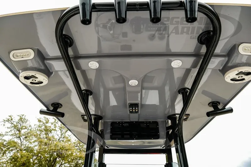 Slide: The Image of 2022 NauticStar 2602 Legacy boat's T-top with rod holders and lighting fixtures. - 32