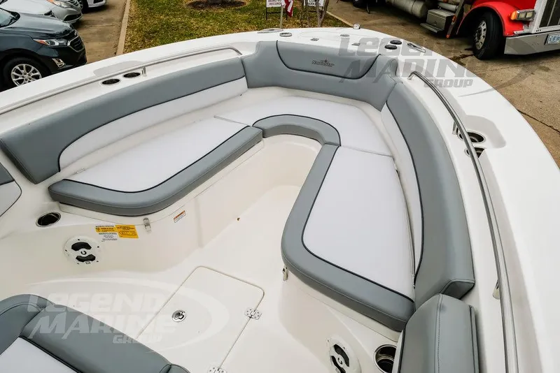 Slide: The Image of 2022 NauticStar 2602 Legacy boat interior with gray and white cushioned seating. - 35
