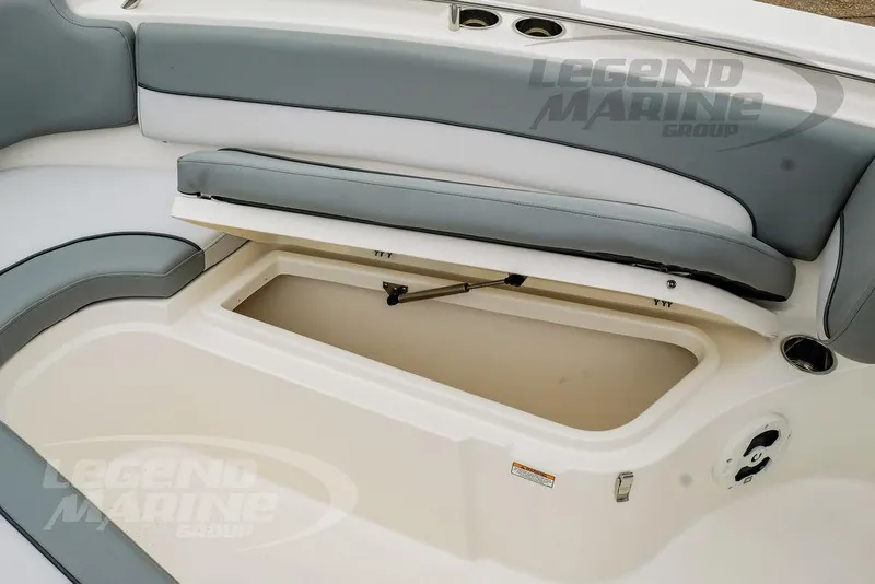 Slide: The Image of 2022 NauticStar 2602 Legacy boat with open storage compartment and cushioned seating. - 39