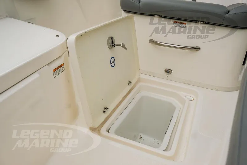 Slide: The Image of 2022 NauticStar 2602 Legacy boat storage compartment with open hatch and seating. - 42