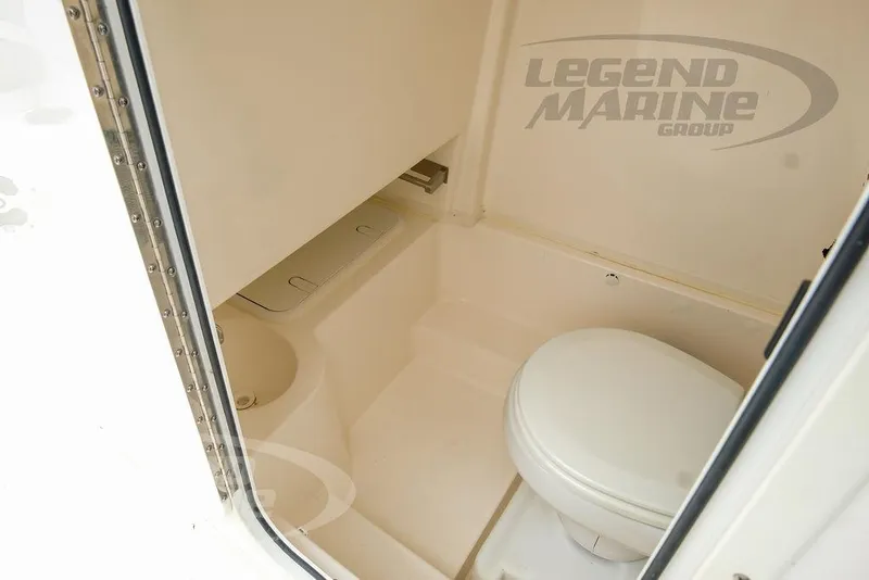 Slide: The Image of 2022 NauticStar 2602 Legacy boat interior bathroom with toilet. - 47