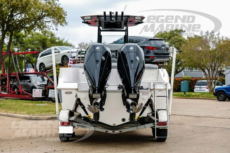 Slide: The Image of 2022 NauticStar 2602 Legacy boat with dual outboard motors on a trailer. - 6