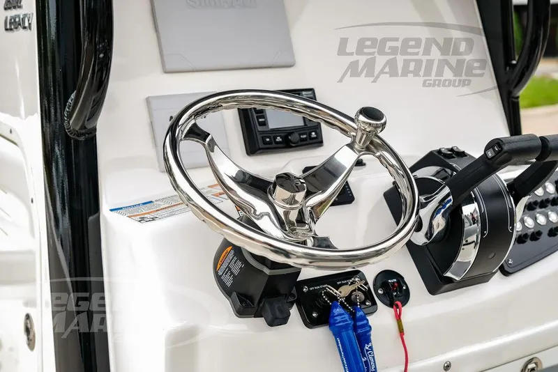 Slide: The Image of 2022 NauticStar 2602 Legacy boat steering wheel and controls, Legend Marine Group branding. - 8