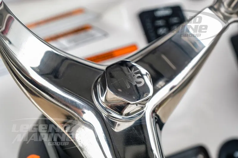 Slide: The Image of Close-up of 2022 NauticStar 2602 Legacy steering wheel with logo detail. - 9
