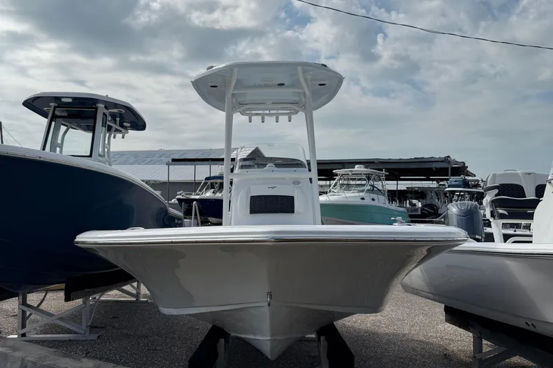 Slide: The Image of 2025 Tidewater 2210 Carolina Bay boat displayed at a marina under cloudy skies. - 11