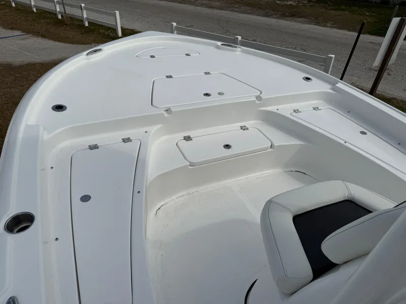 Slide: The Image of 2025 Tidewater 2210 Carolina Bay boat deck with seating and storage compartments. - 2