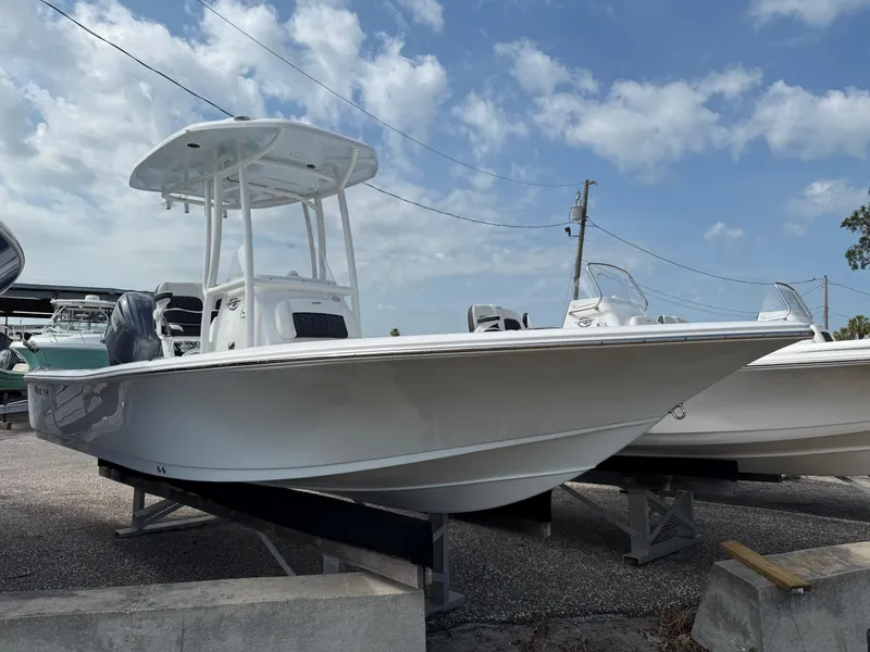 Slide: The Image of 2025 Tidewater 2210 Carolina Bay boat on display under a partly cloudy sky. - 7