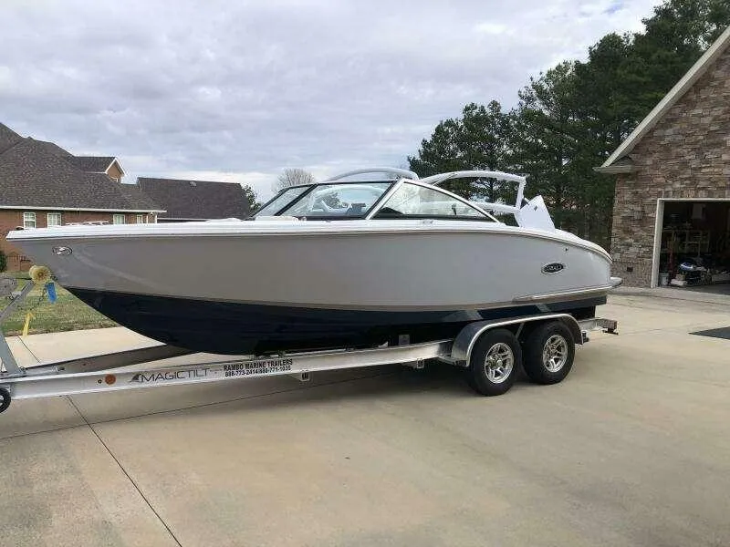 The Image of 2022 Cobalt CS22 boat on trailer in residential driveway. - 0