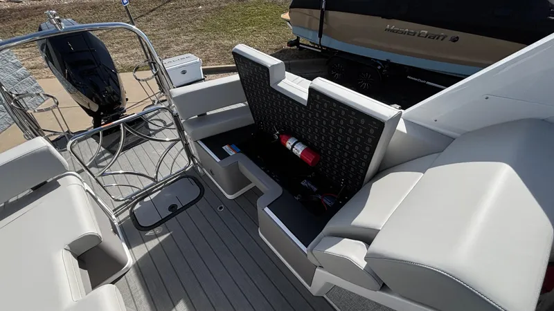Slide: The Image of 2025 Balise Helix 24C boat interior with seating, outdoor setting, and clear blue sky. - 16