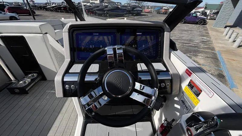 Slide: The Image of Cockpit of 2025 Balise Helix 24C boat with steering wheel and control panel. - 21