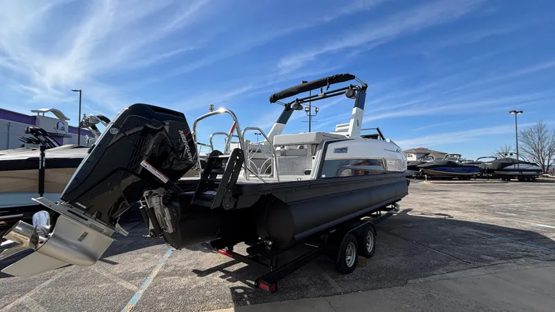 Slide: The Image of 2025 Balise Helix 24C boat on trailer under clear blue sky. - 28