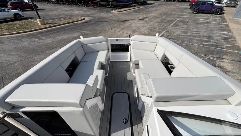 Slide: The Image of 2025 Balise Helix 24C boat interior with modern helm and seating at a dealership. - 7