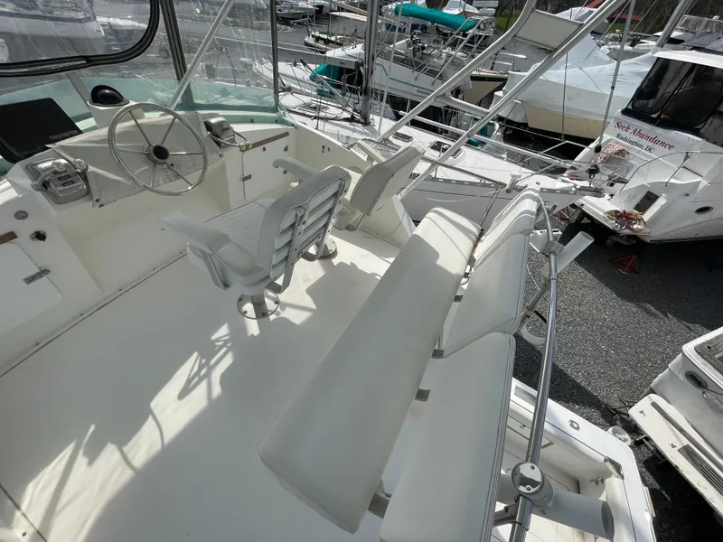 Slide: The Image of 1978 Bertram 33 Flybridge Cruiser with spacious helm and seating area. - 10