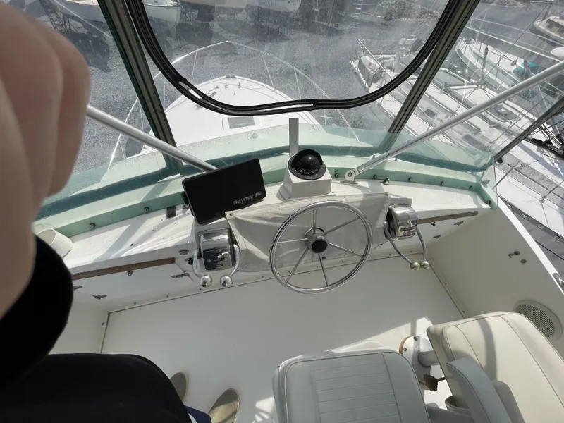 Slide: The Image of 1978 Bertram 33 Flybridge Cruiser helm with steering wheel and navigation equipment. - 12