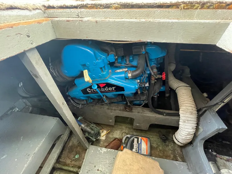 Slide: The Image of Engine compartment of a 1978 Bertram 33 Flybridge Cruiser with a blue Crusader engine. - 14