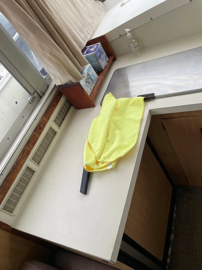 Slide: The Image of Interior of a 1978 Bertram 33 Flybridge Cruiser with a yellow cloth on the counter. - 18