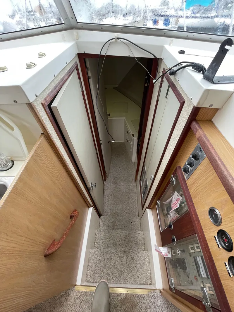 Slide: The Image of 1978 Bertram 33 Flybridge Cruiser interior with stairs and control panel. - 20