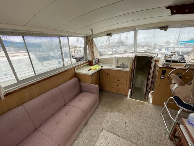 Slide: The Image of Interior of a 1978 Bertram 33 Flybridge Cruiser with sofa and helm station. - 22